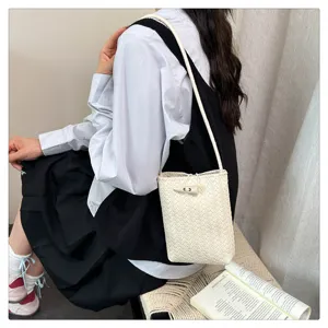 Detailed view of stylish woven phone crossbody bag with horn buckle, perfect daily accessory.