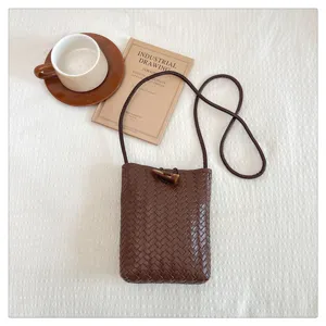 Minimalist woven PU leather phone crossbody bag with chic horn buckle for women daily use.