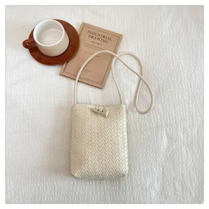 Minimalist PU woven crossbody phone bag with horn buckle, solid color fashion shoulder bag.