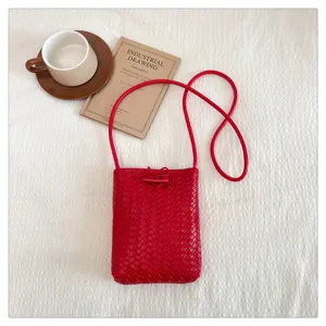 Detail view of red woven pu leather phone crossbody bag with chic horn buckle closure showcase.