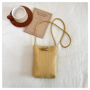 Chic woven PU leather crossbody phone bag with horn buckle, stylish mini shoulder bag for women.