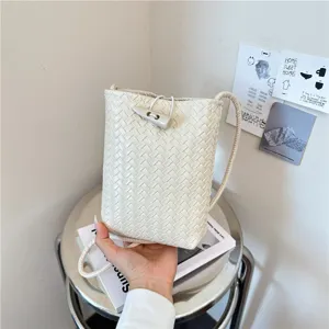 Woven PU leather crossbody phone bag for women, minimalist shoulder bag with horn buckle.