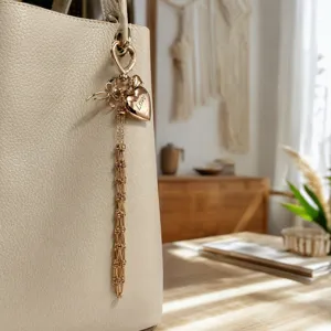 Metal mesh lipstick holder bag pendant, chic heart charm and long tassel design for women.