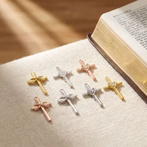 Detailed shot of sparkling heart and bowknot cross pendants with rhinestones in various colors.