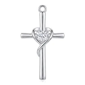 Close-up detail of silver cross pendant featuring a sparkling heart-shaped zircon stone.