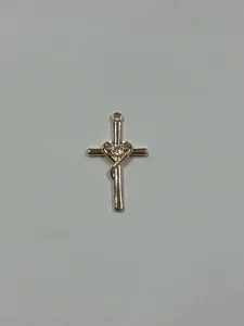 Detail view of elegant rose gold cross pendant featuring interlocking heart and sparkling zircon stone.