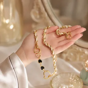 Fashion metal bag chain strap with black heart charms and white leather woven design.