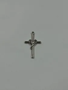 Detailed view of silver cross heart zircon pendant, shiny crystal jewelry accessory.