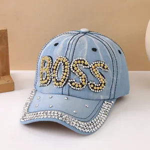 Cappellino da baseball in denim azzurro con lettere BOSS in strass e borchie luminose.