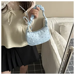 Korean sweet light blue polka dot bow shoulder bag, trendy pleated handle chic design detail.