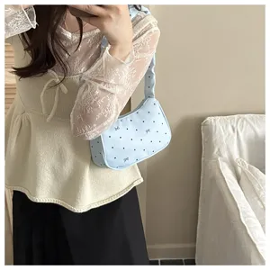 Light blue bow shoulder bag detail, stylish sweet aesthetic handbag with polka dot design.