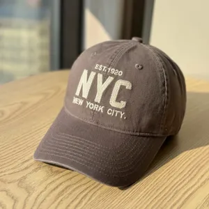 Brown embroidered NYC cotton baseball cap, soft top design, casual vintage headwear detail.