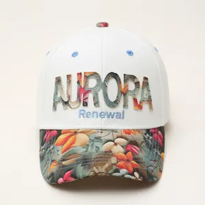Detailed view of the white baseball cap with floral brim and embroidery text AURORA.