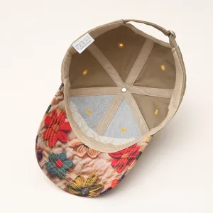 Detailed interior view of a casual beige baseball cap with floral embroidered brim and tag.