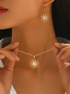 Gold sun moon pendant necklace and earrings set detail view showcasing sparkling rhinestones.