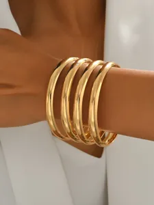 Bracelet jonc empilé en métal doré chic, bijoux géométrique rond minimaliste et lisse.