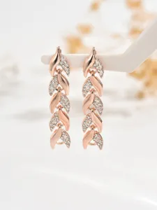 Elegant rose gold crystal leaf dangling earrings, intricate pave rhinestone drop detail for daily wear.