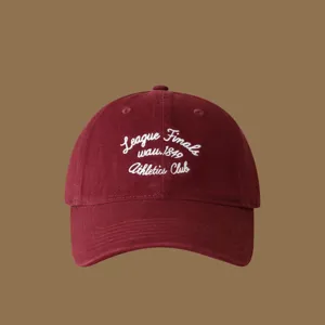 Burgundy baseball cap with white embroidered letters, detailed view of the stylish hat.