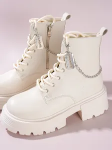 Beige platform combat boots with chain razor pendant, stylish goth streetwear footwear style.