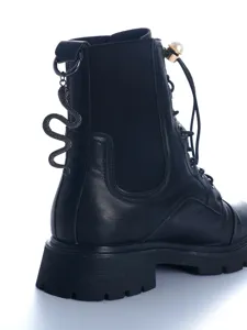 Black leather gothic combat boots featuring metal snake pendant and pearl ankle detail.