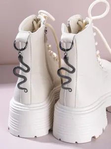 Goth vintage platform combat boots with a cool metal snake pendant on the heel loop. Perfect detail.
