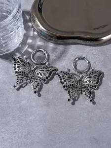 Detailed view of dark style hollow butterfly shoe charms, retro metal boot jewelry pendants.