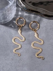 Detailed closeup of punk style metal snake shoe charms, stylish gold tone boot accessories.