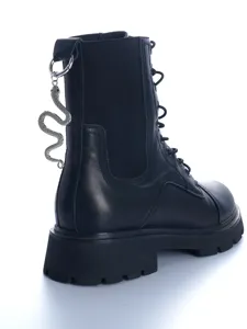 Gothic style black leather combat boots detail with silver snake pendant hanging from back heel.