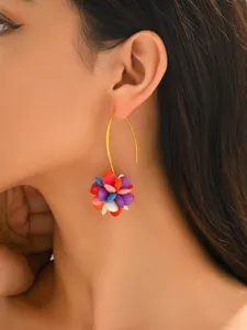 Close-up detail shot of colorful acrylic beaded flower cluster hook earrings worn by model.