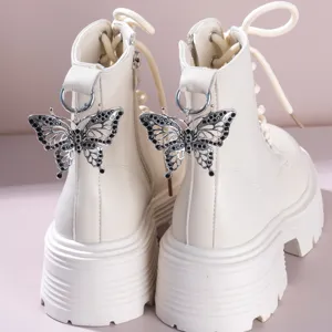 White platform combat boots with sparkling rhinestone butterfly pendant for women.