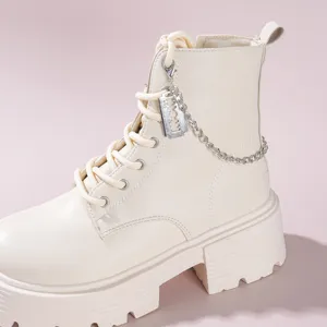 Gothic style beige platform combat boots featuring a metal chain and razor blade pendant.