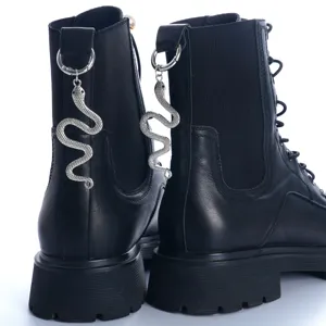 Gothic black leather combat boots with metallic silver snake charm pendant, vintage style.