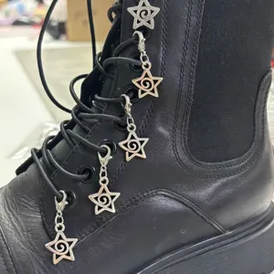Punk star shoe charms on black leather boots, metal pentagram boot accessories for women.