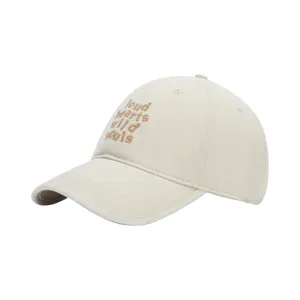 Close-up detail of beige washed baseball cap with brown embroidered letter typography.