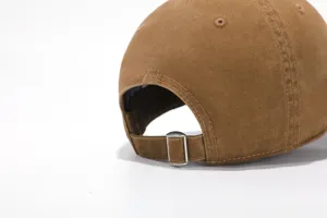 Detailed view of the vintage washed brown baseball cap featuring an adjustable metal buckle strap.