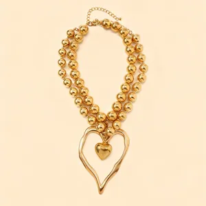 Double layer gold beaded necklace with exaggerated irregular heart pendant for women jewelry.