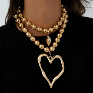 Exaggerated gold bead layered necklace with irregular heart pendants for women fashion style.