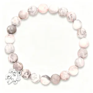 Pink zebra jasper beaded bracelet detail showing texture and silver unicorn charm.