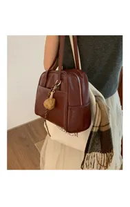Detail view of a retro brown leather shoulder bag, stylish casual handbag for women's daily wear.