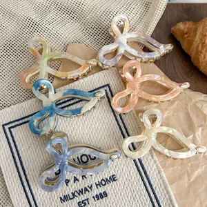 Stylish acetate hair claw clip with bow design, elegant detail view for women's daily wear.