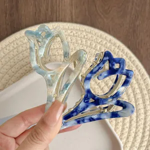 Close up of exquisite tulip hair claw detail, elegant marble pattern design hairpin.