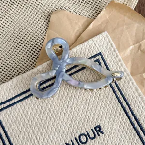 Elegant blue acetate hair claw clips featuring chic bow knot design and metal accents.