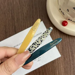 Acetate hair clips set with gold lettering, chic side clips for women and girls daily styling.