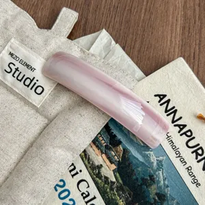 Korean style curved acetate hair clip, pink minimalist barrette for chic hairstyles and daily wear.