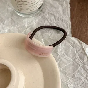 Minimalist acetate curved ponytail hair tie with retro pink design and elegant daily style.