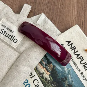 Minimalist burgundy curved acetate hair clip, chic french barrette for elegant ponytail styles.