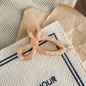 Elegant pink acetate hair claw clip with unique geometric loop design for daily stylish updos.