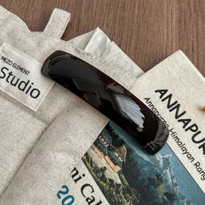 Dark brown acetate curved hair clip detail, minimalist barrette spring clip for elegant hairstyles.