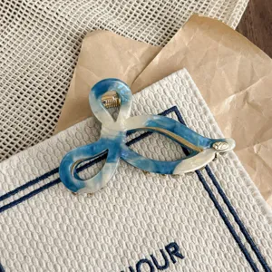 Blue and white acetate hair claw clip, elegant twisted bow design for women's daily hairstyles.