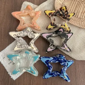 Close-up detail of hollow star hair claws in various marble and color-blocked patterns.